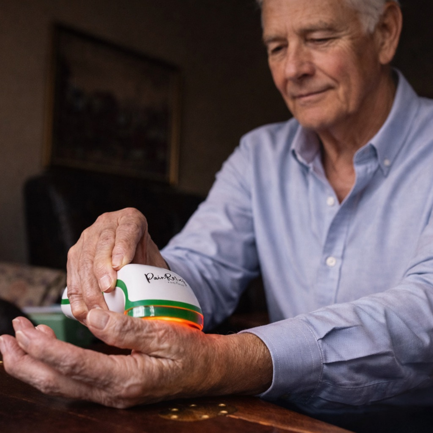 older gentleman using red light therapy for pain relief and arthritis